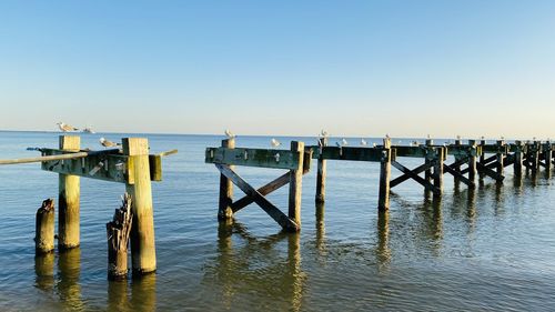 Pier over sea against clear sky