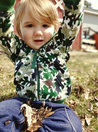 Portrait of cute baby girl on field