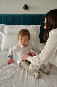 Portrait of cute baby boy sleeping on bed at home