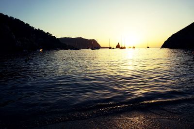 Scenic view of sea against clear sky during sunset