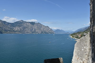 Scenic view of sea and mountains against sky