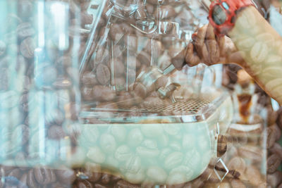 Close-up of hand holding glass of table