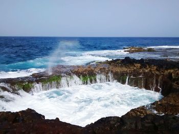 Scenic view of sea against cloudy sky