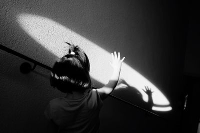 High angle view of girl standing by wall