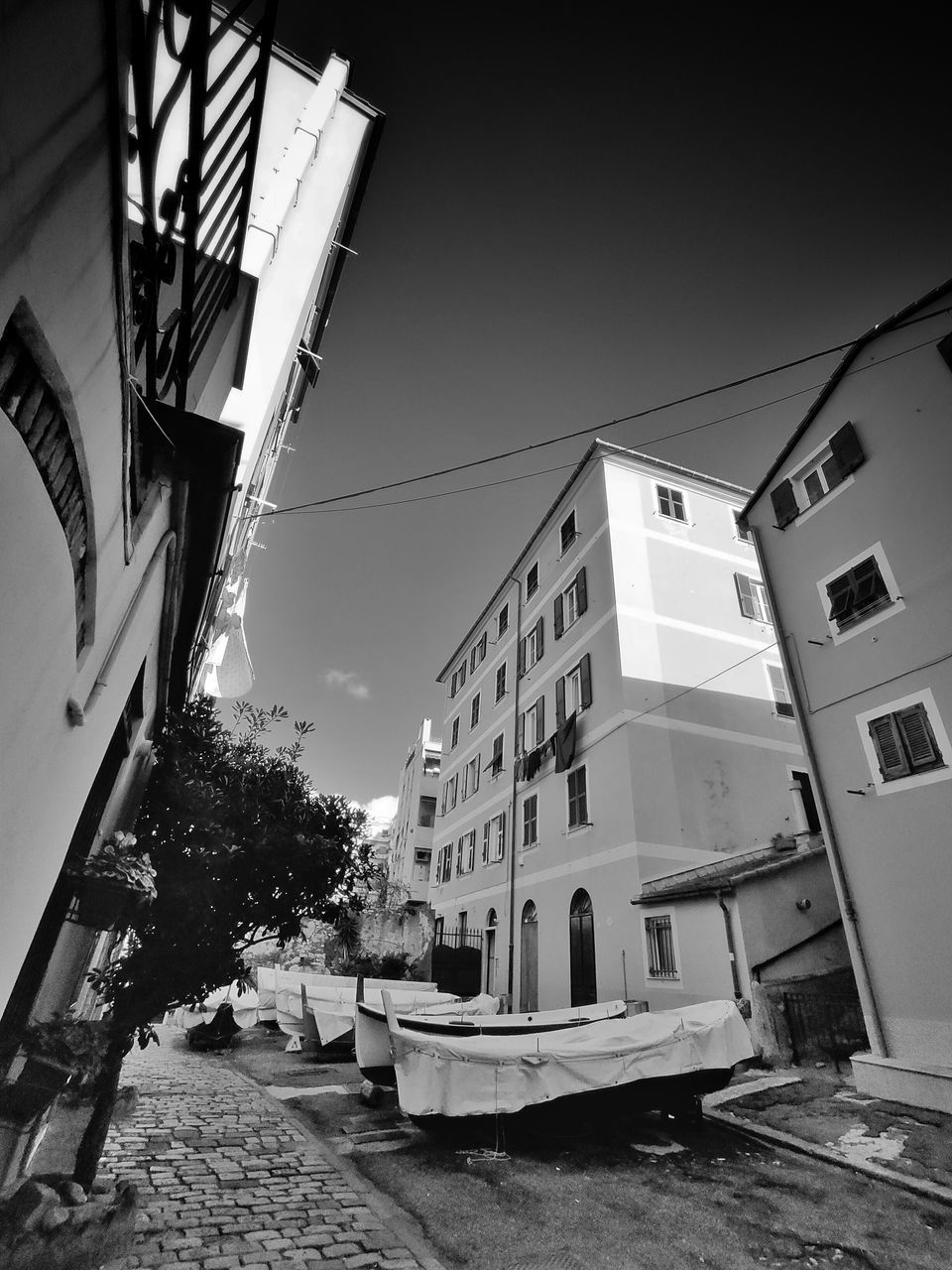 LOW ANGLE VIEW OF BUILDINGS AND STREET AGAINST SKY