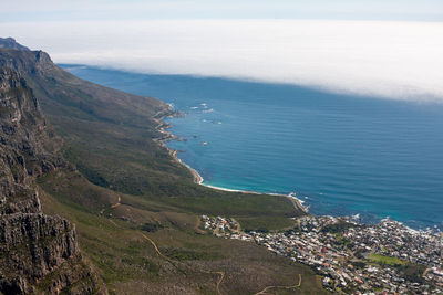 High angle view of sea and mountains against sky