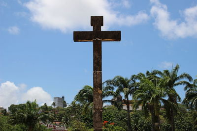 Low angle view of cross against sky