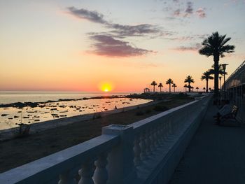 Scenic view of beach against sky during sunset