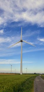 Windmill on field against sky