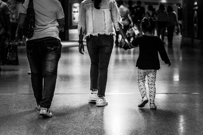 Low section of people walking at station