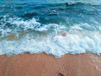 High angle view of waves rushing towards shore