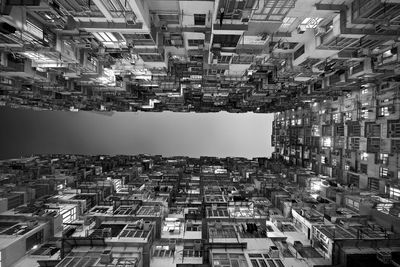 Directly below shot of buildings against clear sky