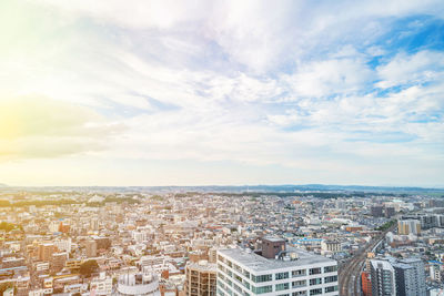 High angle view of city against cloudy sky