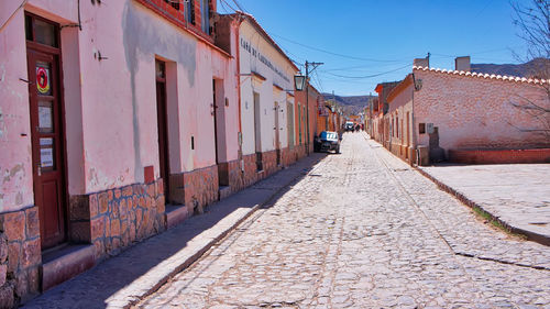 Footpath amidst buildings in city