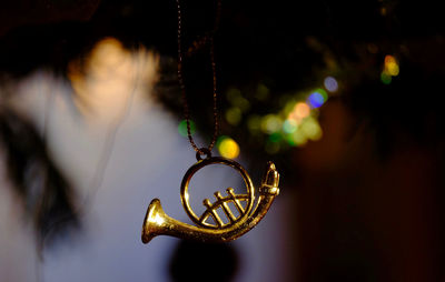 Close-up of trumpet decoration hanging outdoors at night