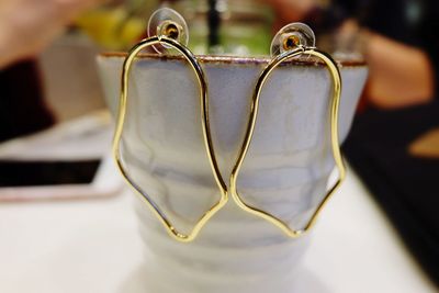 Close-up of metal hanging on table