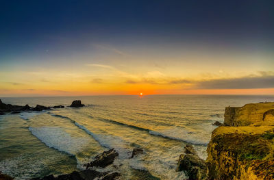 Scenic view of sea against sky during sunset