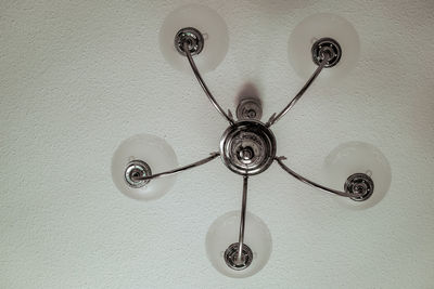 Low angle view of electric lamp hanging on ceiling