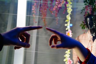 Finger of a man and woman almost touching