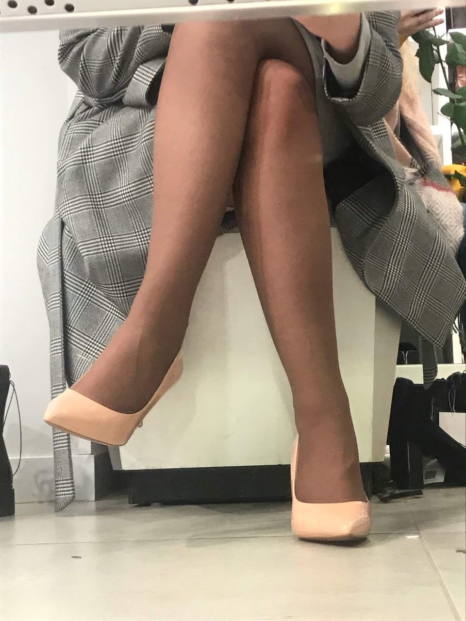 LOW SECTION OF WOMAN SITTING ON SEAT