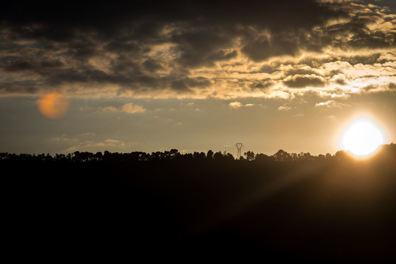 SCENIC VIEW OF SILHOUETTE FIELD AGAINST SKY AT SUNSET