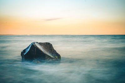 Scenic view of sea against sky at sunset