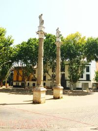 Statue against building