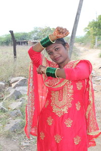 Portrait of smiling young woman standing outdoors