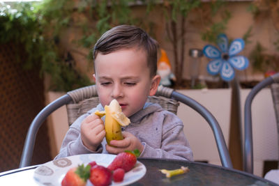 Portrait of young woman with food on table