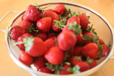 High angle view of strawberries in bowl on table