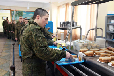 Side view of a man preparing food