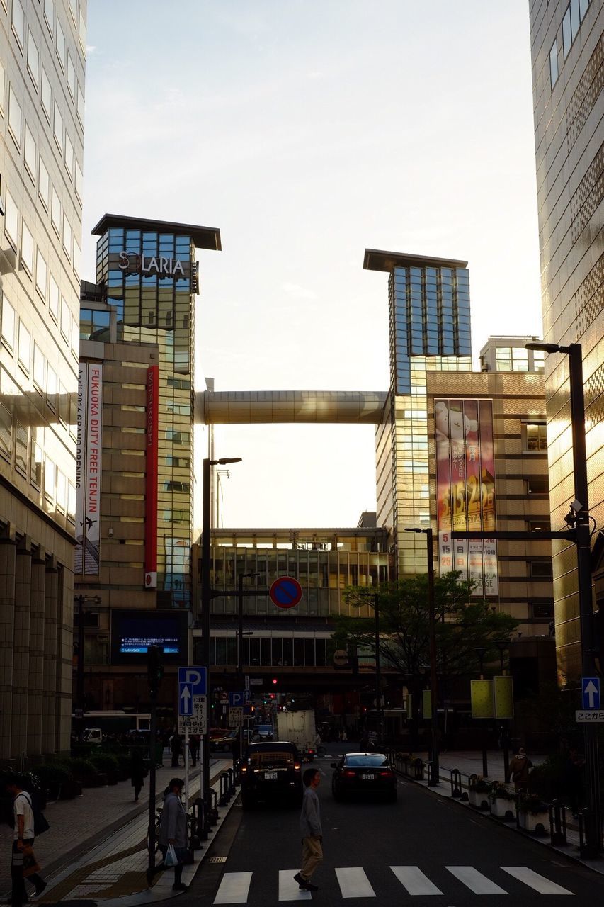 architecture, building exterior, built structure, city, transportation, street, city life, car, building, land vehicle, mode of transport, incidental people, road, sky, day, city street, residential building, outdoors, clear sky