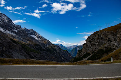 Scenic view of mountains against blue sky