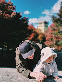 Man with daughter sitting outdoors