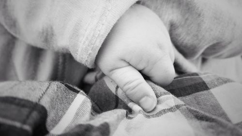 Close-up of baby holding hands