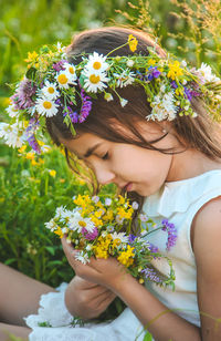 Midsection of bride holding bouquet