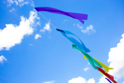 Low angle view of flag against blue sky