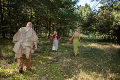 Rear view of woman standing on field