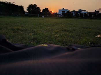 Scenic view of field against sky at sunset