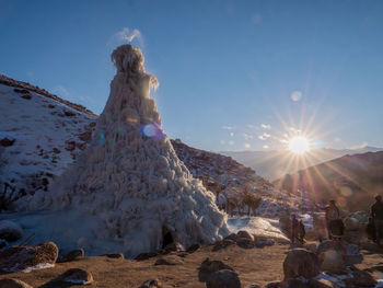 Scenic view of snow covered land during sunny day