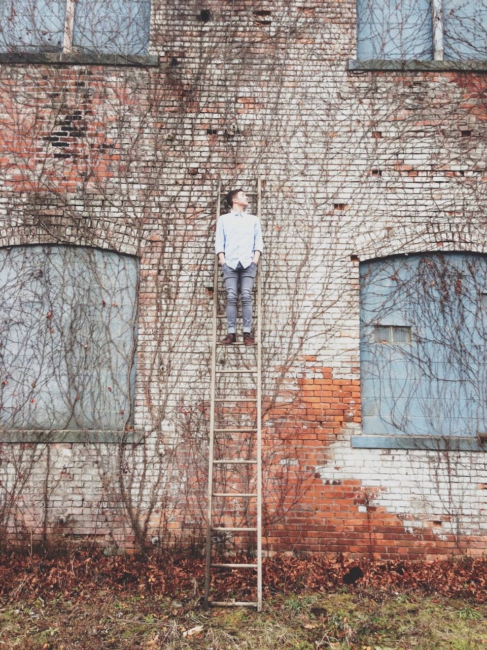 built structure, architecture, building exterior, wall - building feature, brick wall, full length, lifestyles, standing, wall, abandoned, window, day, house, protection, outdoors, graffiti, door, stone wall