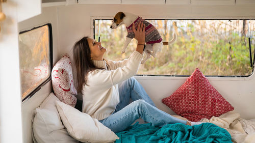 Rear view of female friends sitting at home