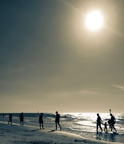 People on beach against sky