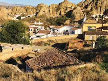 High angle view of houses on field against mountains