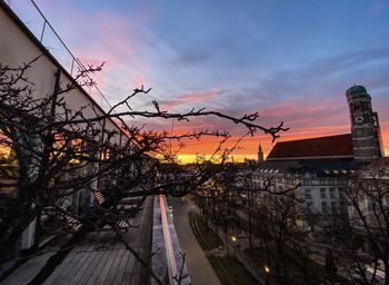 High angle view of street by buildings against sky during sunset