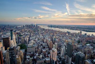 High angle view of modern buildings against sky during sunset