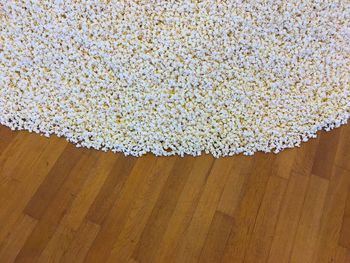 High angle view of white berries on hardwood floor