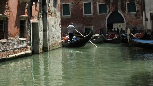 Boats in river with buildings in background