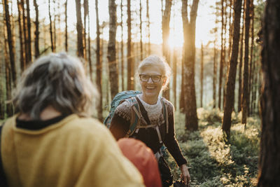 Two senior women hiking in forest