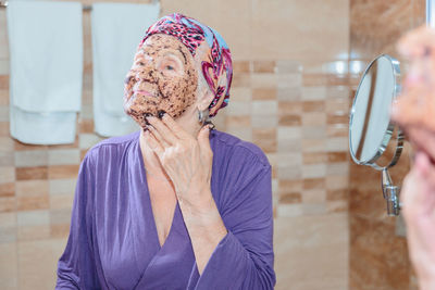 Elderly woman taking care of her face